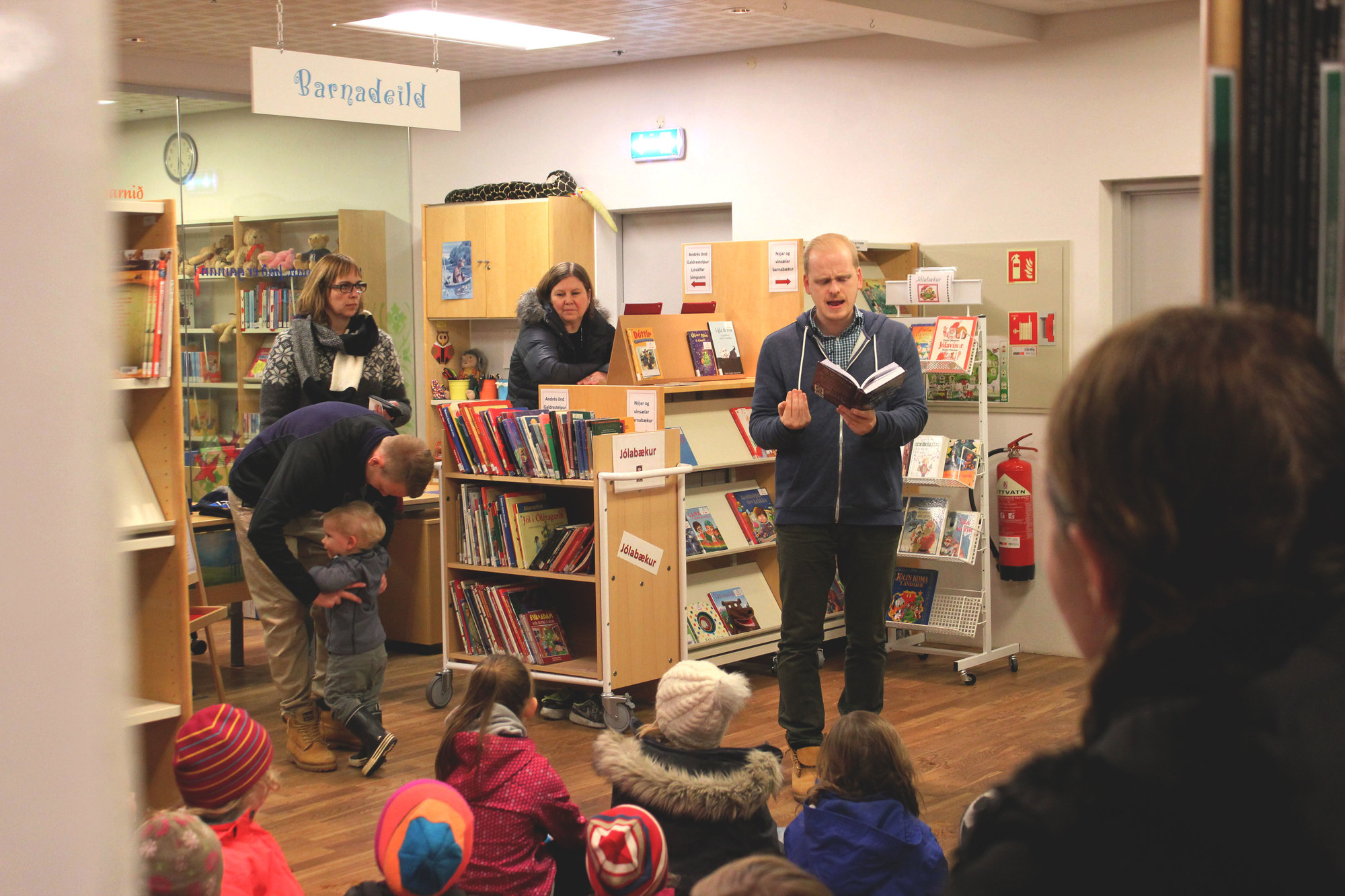 Story time at the Municipal Library: the author Ævar Þór is reading and children and some parents are listening