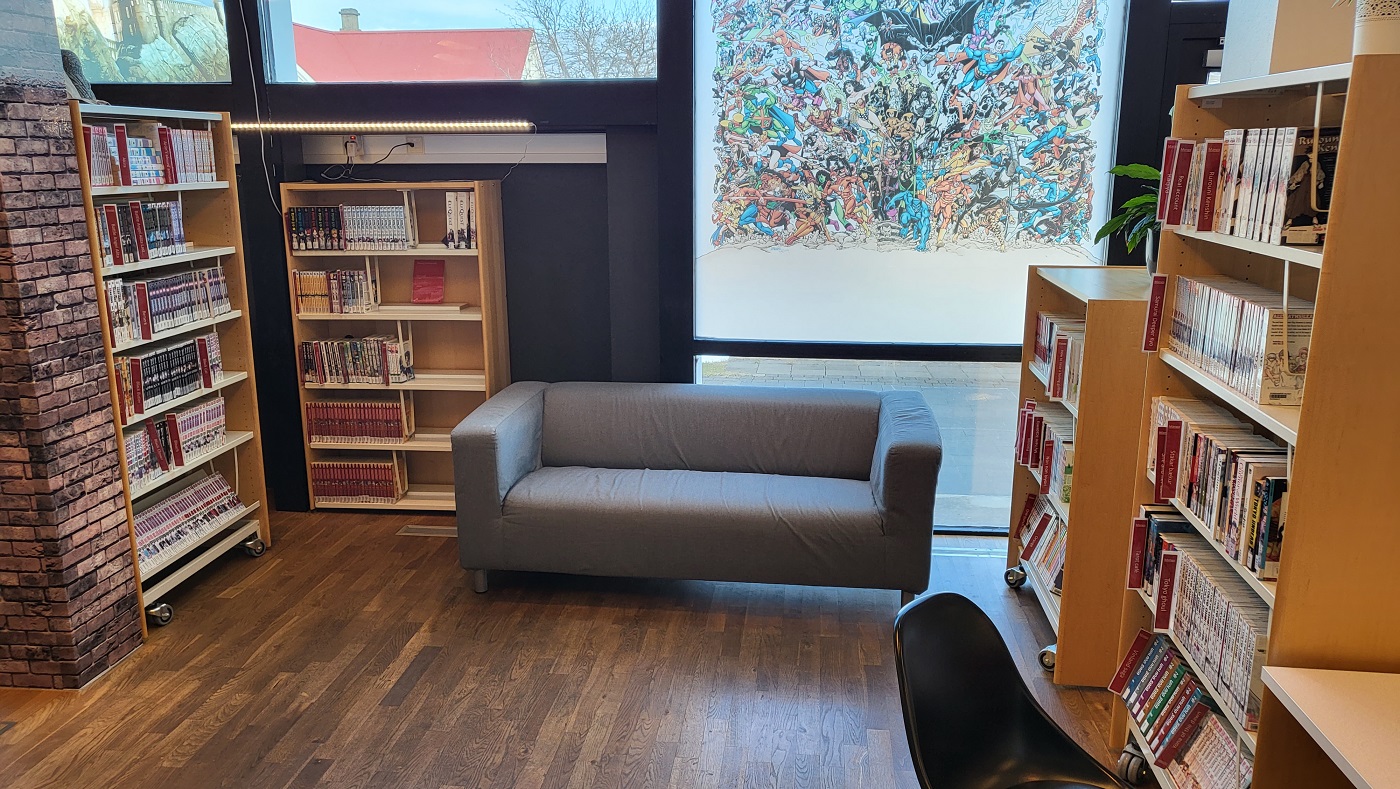 Picture of manga books in shelves and sofa in the middle