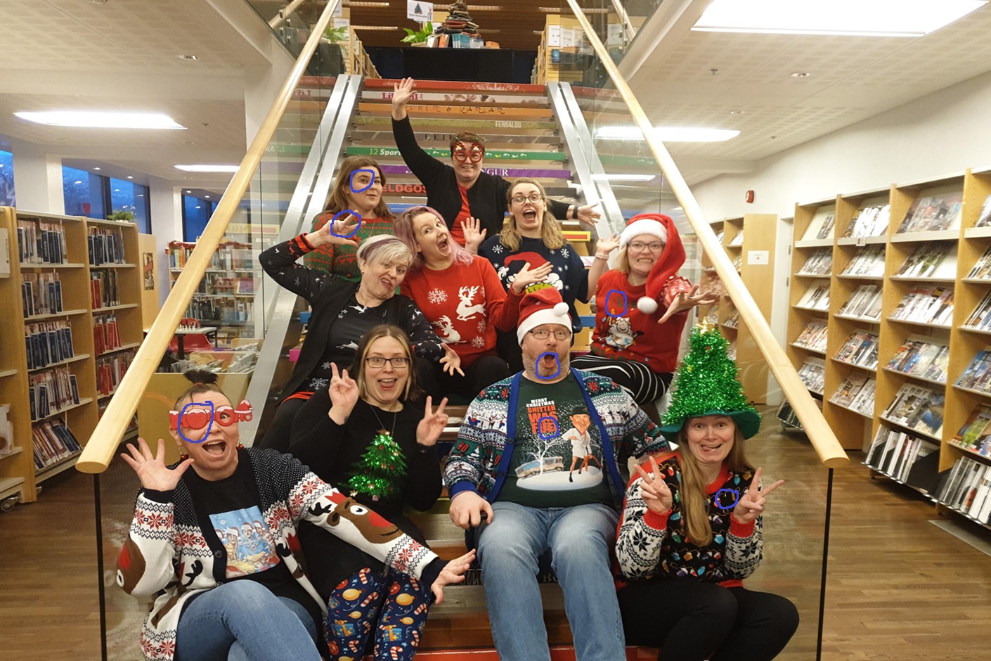Employees of the library and archive museum sitting and wearing Christmas outfits