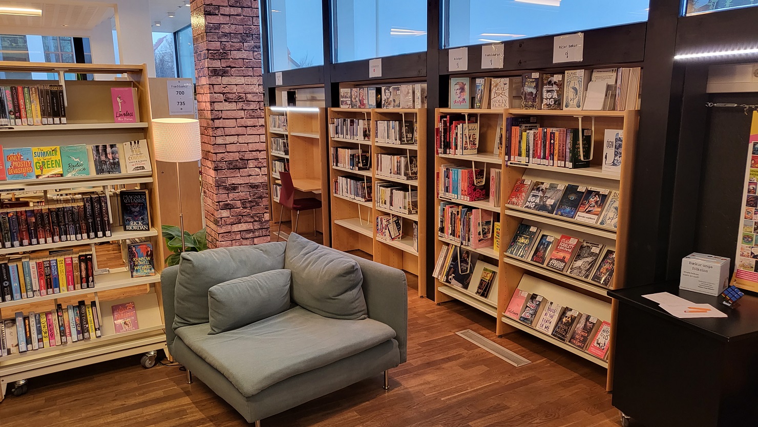 Picture from the youth department, shelves with books and a corner sofa