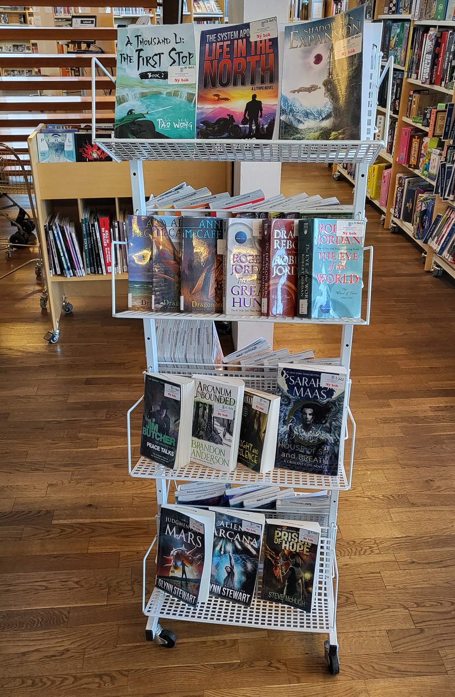 Stand with new sci-fi books and shelves in the background